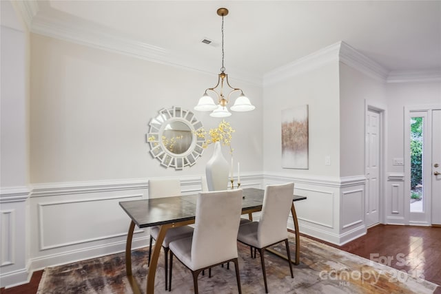 11234 Villa Trace Pl, Charlotte, NC 28277 - dining room featuring wood finished floors, crown molding, a decorative wall, a wainscoted wall, and a chandelier