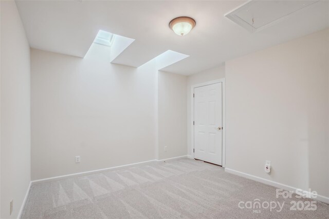 11234 Villa Trace Pl, Charlotte, NC 28277 - empty room with light carpet, attic access, and a skylight