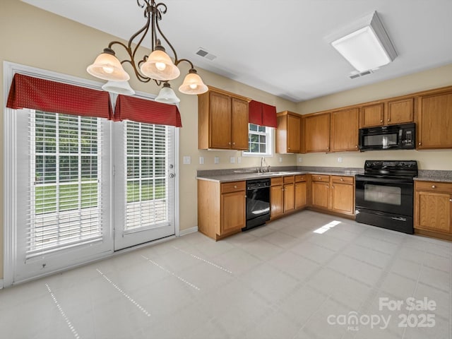 5921 Firethorne Ln, Concord, NC 28025 - kitchen featuring black appliances, a sink, hanging light fixtures, and brown cabinetry