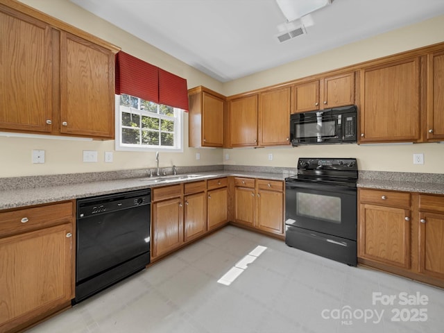 5921 Firethorne Ln, Concord, NC 28025 - kitchen with black appliances, a sink, brown cabinetry, and light stone countertops