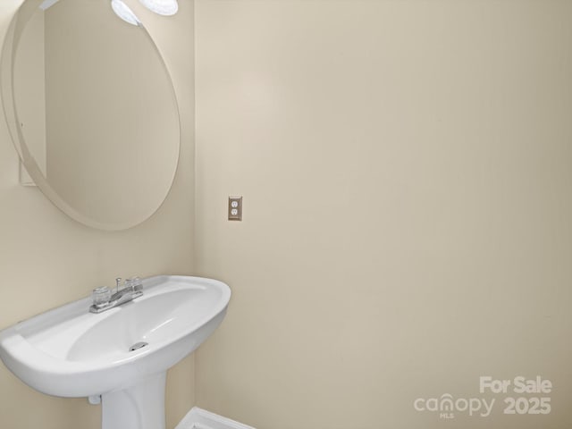 5921 Firethorne Ln, Concord, NC 28025 - bathroom with baseboards and a sink