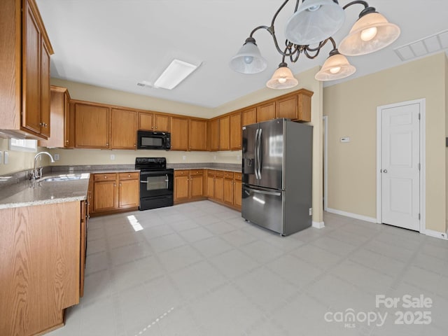 5921 Firethorne Ln, Concord, NC 28025 - kitchen featuring black appliances, a sink, brown cabinets, and pendant lighting