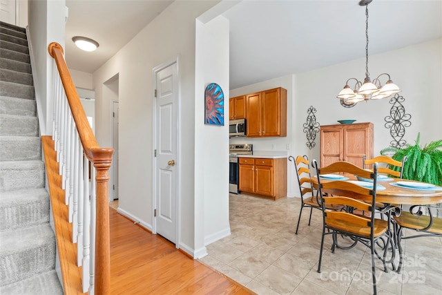 1418 Skidaway St NW Unit 427, Concord, NC 28027 - dining area featuring a chandelier, stairway, and light wood-type flooring
