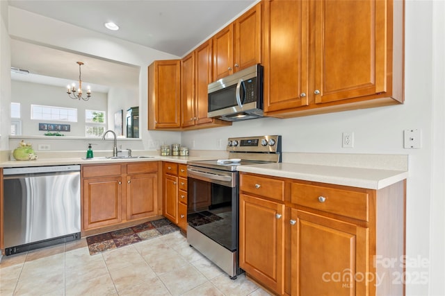1418 Skidaway St NW Unit 427, Concord, NC 28027 - kitchen featuring stainless steel appliances, a chandelier, light countertops, brown cabinets, and recessed lighting