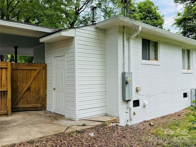 1211 Campus St, Charlotte, NC 28216 - view of side of home featuring a gate and brick siding