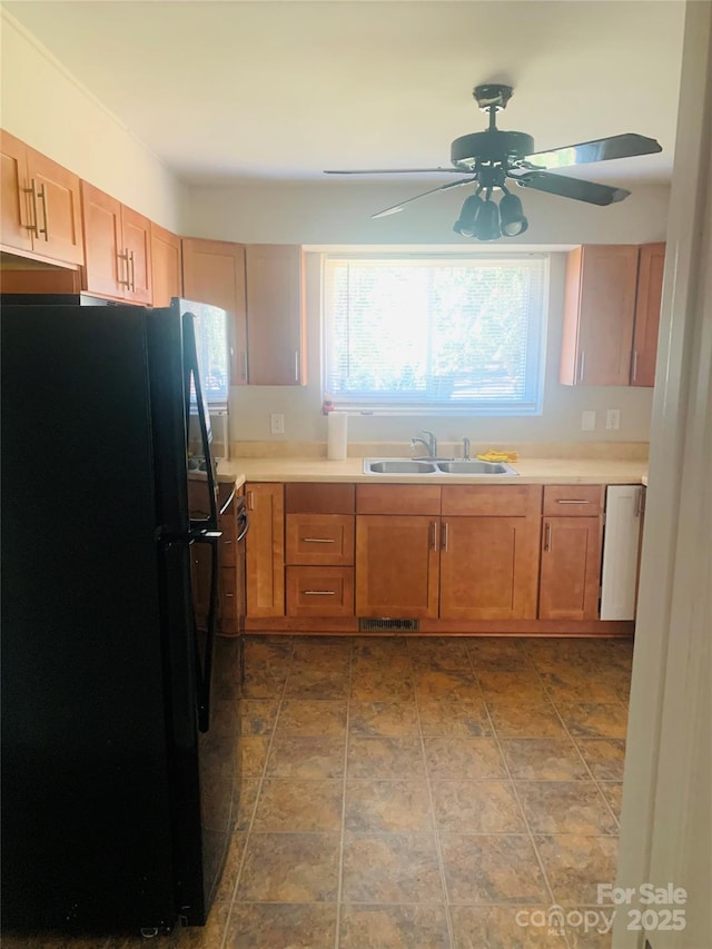 1211 Campus St, Charlotte, NC 28216 - kitchen with freestanding refrigerator, a sink, a ceiling fan, and brown cabinetry