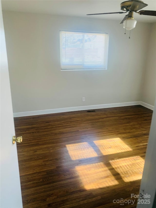 1211 Campus St, Charlotte, NC 28216 - empty room featuring baseboards, a ceiling fan, and dark wood-type flooring