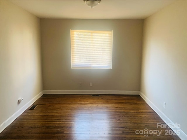 1211 Campus St, Charlotte, NC 28216 - spare room with dark wood-style floors and baseboards