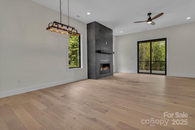 127 View Ridge Parkway, Leicester, NC 28748 - unfurnished living room featuring light wood finished floors, a large fireplace, a ceiling fan, and recessed lighting