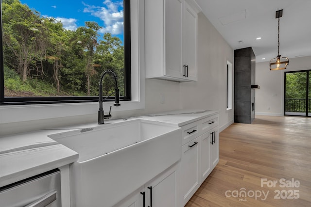 127 View Ridge Parkway, Leicester, NC 28748 - kitchen with light wood-type flooring, white cabinetry, recessed lighting, light stone counters, and pendant lighting
