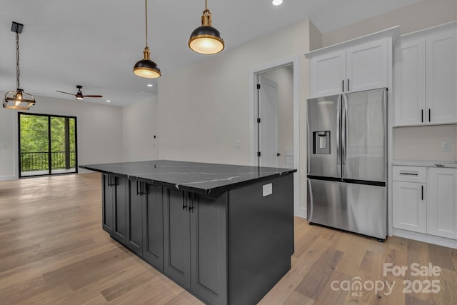 127 View Ridge Parkway, Leicester, NC 28748 - kitchen featuring stainless steel fridge with ice dispenser, light wood finished floors, white cabinetry, ceiling fan, and hanging light fixtures