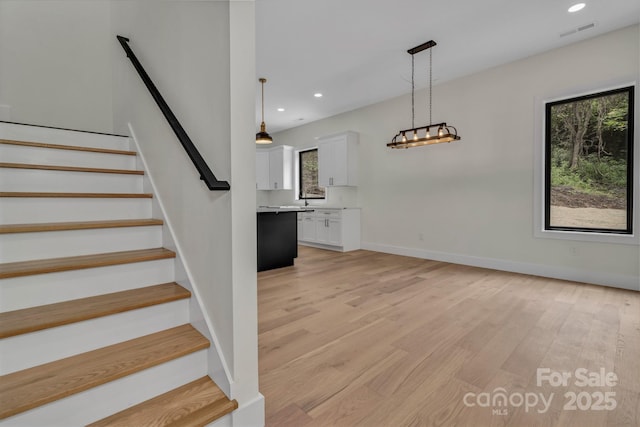 127 View Ridge Parkway, Leicester, NC 28748 - staircase featuring plenty of natural light, wood finished floors, and recessed lighting