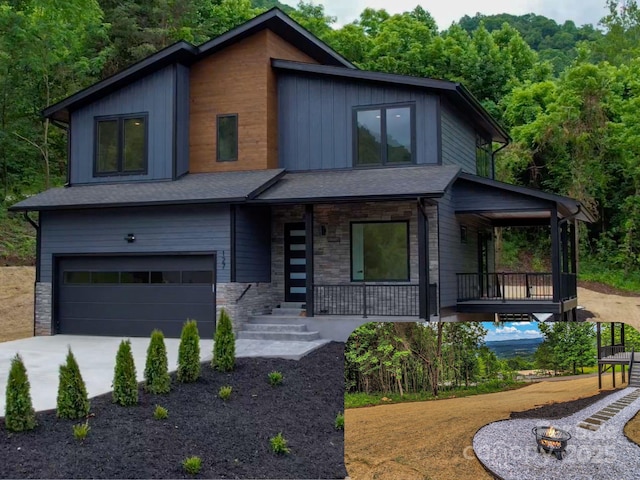 127 View Ridge Parkway, Leicester, NC 28748 - contemporary home featuring a porch, a garage, concrete driveway, and stone siding