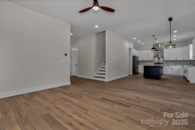 127 View Ridge Parkway, Leicester, NC 28748 - unfurnished living room with a ceiling fan, light wood-style floors, stairs, and recessed lighting