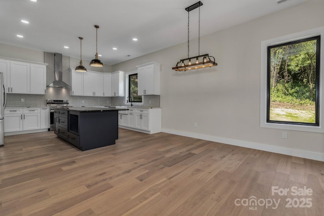 127 View Ridge Parkway, Leicester, NC 28748 - kitchen with wall chimney range hood, appliances with stainless steel finishes, tasteful backsplash, white cabinets, and recessed lighting