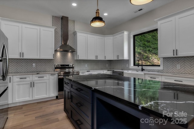 127 View Ridge Parkway, Leicester, NC 28748 - kitchen featuring wall chimney range hood, appliances with stainless steel finishes, decorative backsplash, dark stone counters, and recessed lighting