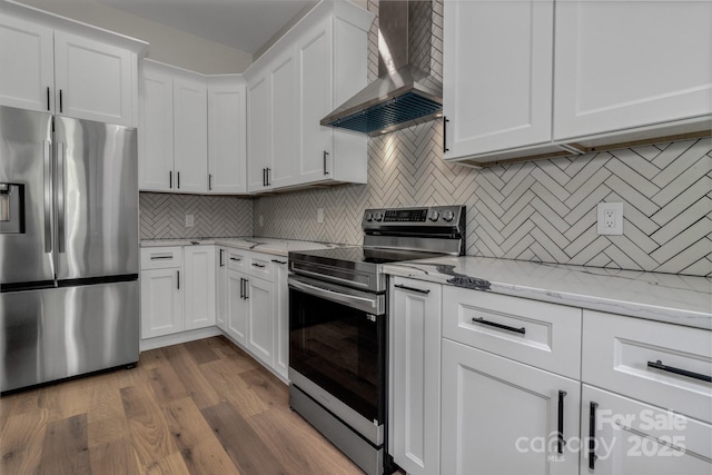 127 View Ridge Parkway, Leicester, NC 28748 - kitchen featuring stainless steel appliances, wall chimney exhaust hood, white cabinetry, backsplash, and wood finished floors