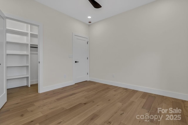 127 View Ridge Parkway, Leicester, NC 28748 - unfurnished bedroom featuring light wood-style floors, a walk in closet, ceiling fan, and a closet