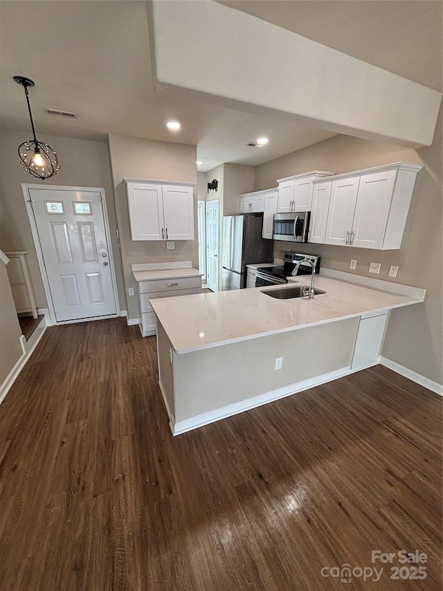 4151 Town Center Rd, Harrisburg, NC 28075 - kitchen featuring appliances with stainless steel finishes, light countertops, dark wood finished floors, a peninsula, and recessed lighting