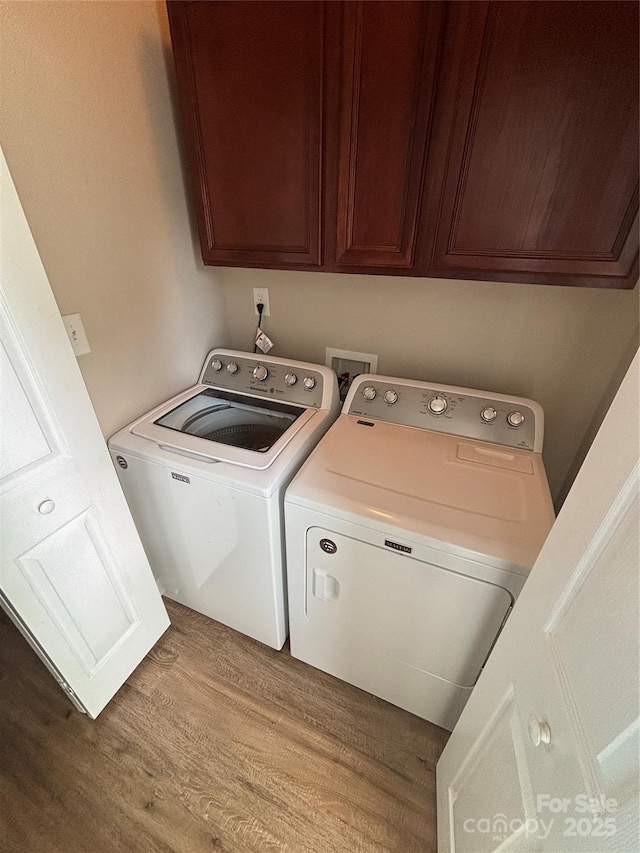 4151 Town Center Rd, Harrisburg, NC 28075 - washroom featuring washer and dryer, wood finished floors, and cabinet space