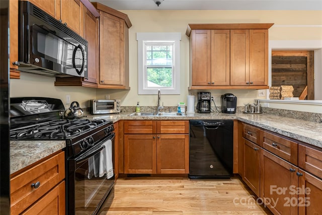 26 Byrdcliffe Ln, Asheville, NC 28805 - kitchen featuring black appliances, light wood finished floors, and brown cabinetry