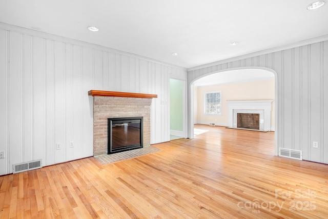 3515 Back Creek Church Rd, Charlotte, NC 28213 - unfurnished living room with a fireplace, hardwood / wood-style floors, and arched walkways
