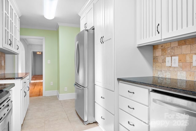 3515 Back Creek Church Rd, Charlotte, NC 28213 - kitchen with appliances with stainless steel finishes, white cabinetry, backsplash, dark stone counters, and ornamental molding
