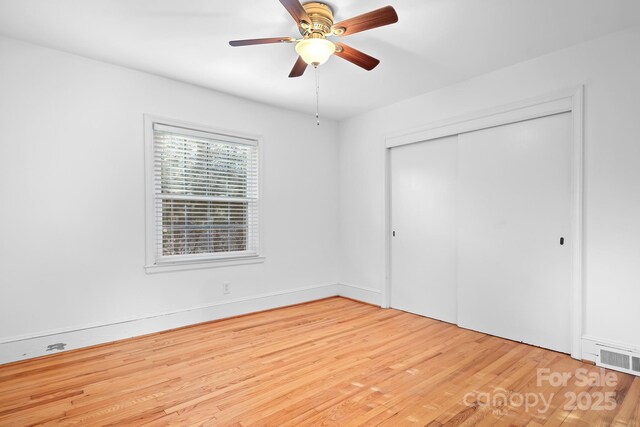 3515 Back Creek Church Rd, Charlotte, NC 28213 - unfurnished bedroom with wood finished floors, a closet, and a ceiling fan