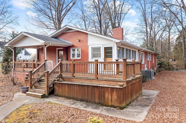3515 Back Creek Church Rd, Charlotte, NC 28213 - rear view of property featuring a chimney, central AC, brick siding, and a wooden deck