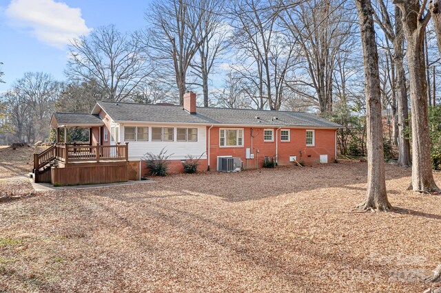 3515 Back Creek Church Rd, Charlotte, NC 28213 - back of house with central air condition unit, a chimney, a deck, brick siding, and roof with shingles