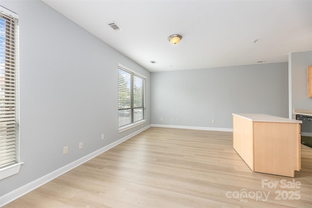 411 W Washington St, Greensboro, NC 27401 - unfurnished living room featuring light wood finished floors and baseboards