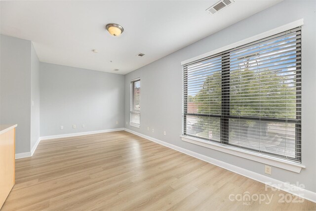 411 W Washington St, Greensboro, NC 27401 - empty room featuring light wood-style flooring and baseboards