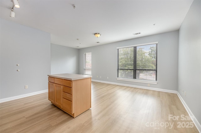 411 W Washington St, Greensboro, NC 27401 - spare room with light wood finished floors, healthy amount of natural light, and baseboards