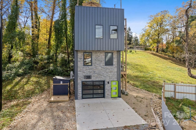 28 Carrick Ln, Brevard, NC 28712 - view of property exterior with board and batten siding, stone siding, driveway, a garage, and a yard