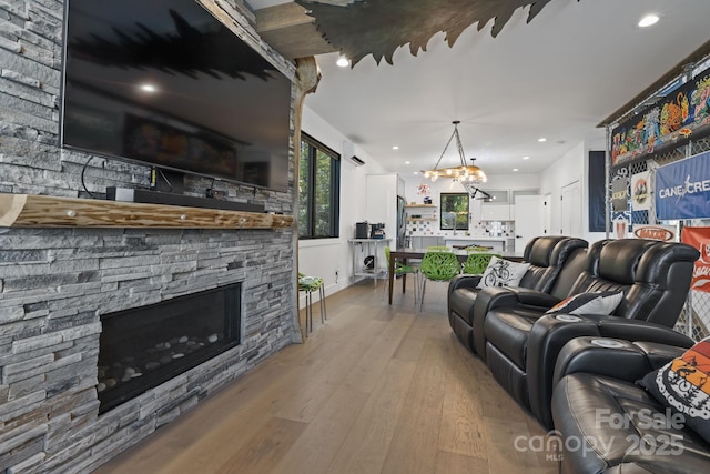 28 Carrick Ln, Brevard, NC 28712 - living area featuring light wood-style flooring, a fireplace, a chandelier, recessed lighting, and baseboards