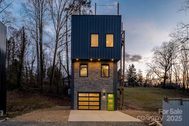 28 Carrick Ln, Brevard, NC 28712 - contemporary home featuring stone siding, concrete driveway, a garage, and board and batten siding