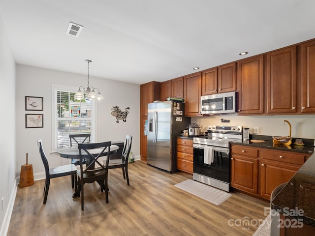 1836 Fairlawn Ct, Rock Hill, SC 29732 - kitchen with stainless steel appliances, light wood-type flooring, brown cabinetry, decorative light fixtures, and recessed lighting