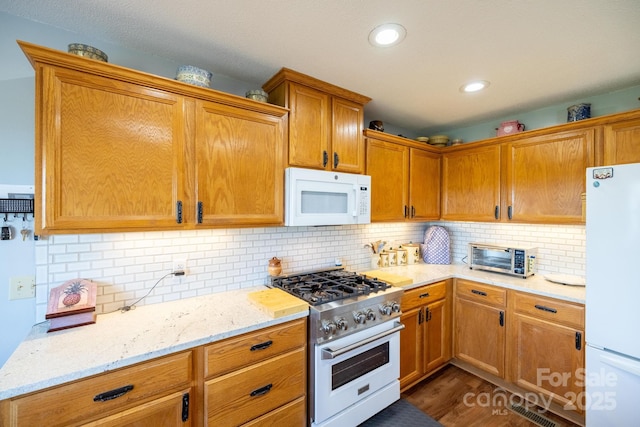 347 Hickory Mountain Rd, Sparta, NC 28675 - kitchen with white appliances, light stone countertops, backsplash, and recessed lighting