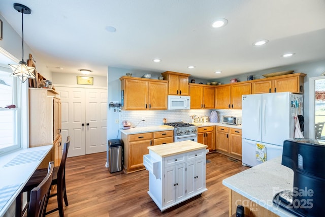 347 Hickory Mountain Rd, Sparta, NC 28675 - kitchen with white appliances, wood finished floors, backsplash, pendant lighting, and recessed lighting