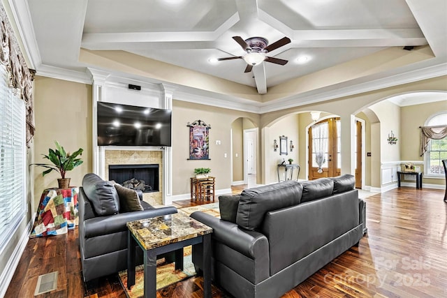 1616 Indian Springs Dr NW, Conover, NC 28613 - living room featuring arched walkways, ceiling fan, a tile fireplace, dark wood-style floors, and ornamental molding
