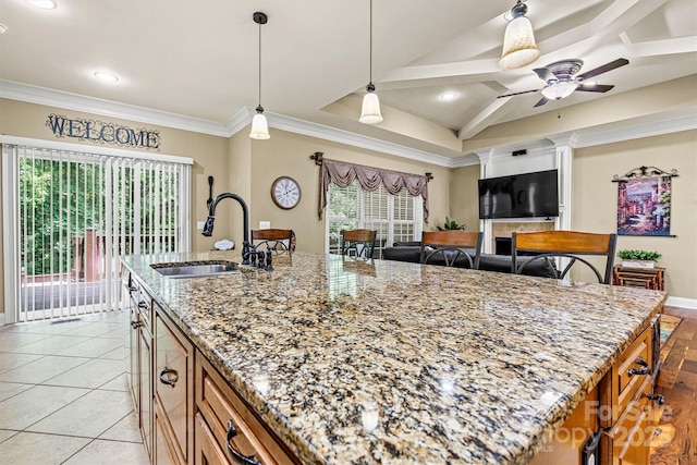 1616 Indian Springs Dr NW, Conover, NC 28613 - kitchen with a sink, a ceiling fan, light stone countertops, pendant lighting, and a kitchen island with sink