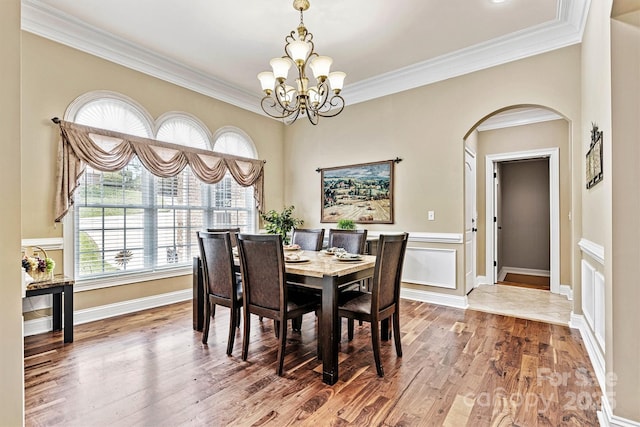 1616 Indian Springs Dr NW, Conover, NC 28613 - dining space featuring arched walkways, a chandelier, wood finished floors, ornamental molding, and baseboards