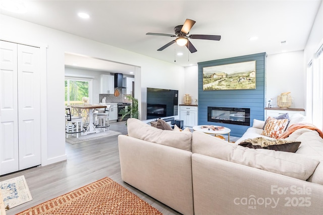 2116 Eastway Dr, Charlotte, NC 28205 - living room featuring a large fireplace, wood finished floors, a ceiling fan, and recessed lighting