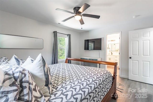 2116 Eastway Dr, Charlotte, NC 28205 - bedroom featuring light wood-type flooring, ensuite bathroom, and ceiling fan