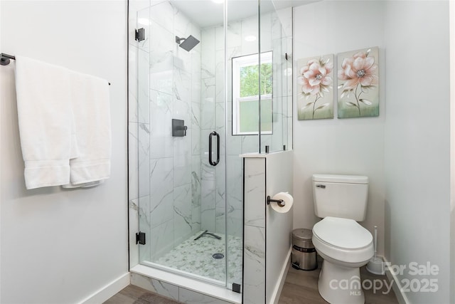 2116 Eastway Dr, Charlotte, NC 28205 - full bath with baseboards, toilet, wood finished floors, and a marble finish shower