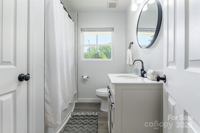 2116 Eastway Dr, Charlotte, NC 28205 - full bathroom featuring vanity, wood finished floors, baseboards, and toilet