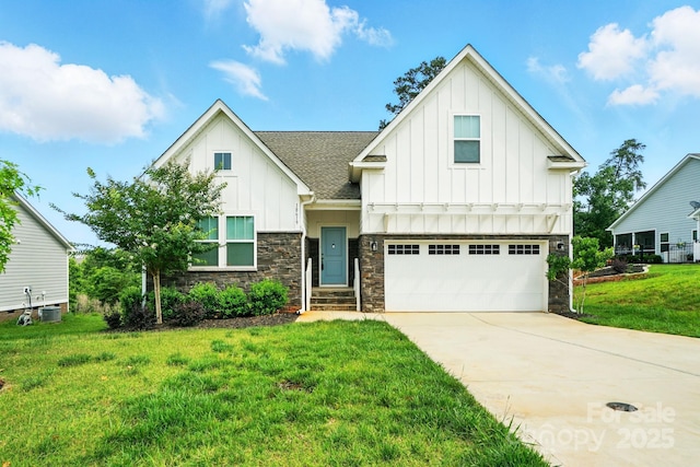 18619 Mainsail Ct, Lancaster, SC 29720 - view of front of home with board and batten siding, stone siding, a front yard, driveway, and a garage