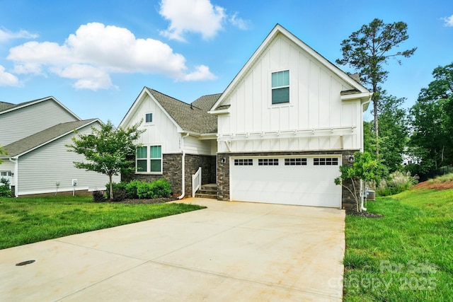 18619 Mainsail Ct, Lancaster, SC 29720 - view of front of house with board and batten siding, an attached garage, driveway, stone siding, and a front yard
