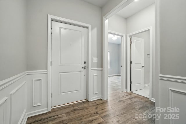 18619 Mainsail Ct, Lancaster, SC 29720 - corridor featuring a wainscoted wall, wood finished floors, and a decorative wall