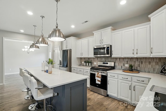 18619 Mainsail Ct, Lancaster, SC 29720 - kitchen with stainless steel appliances, a center island, white cabinetry, and recessed lighting
